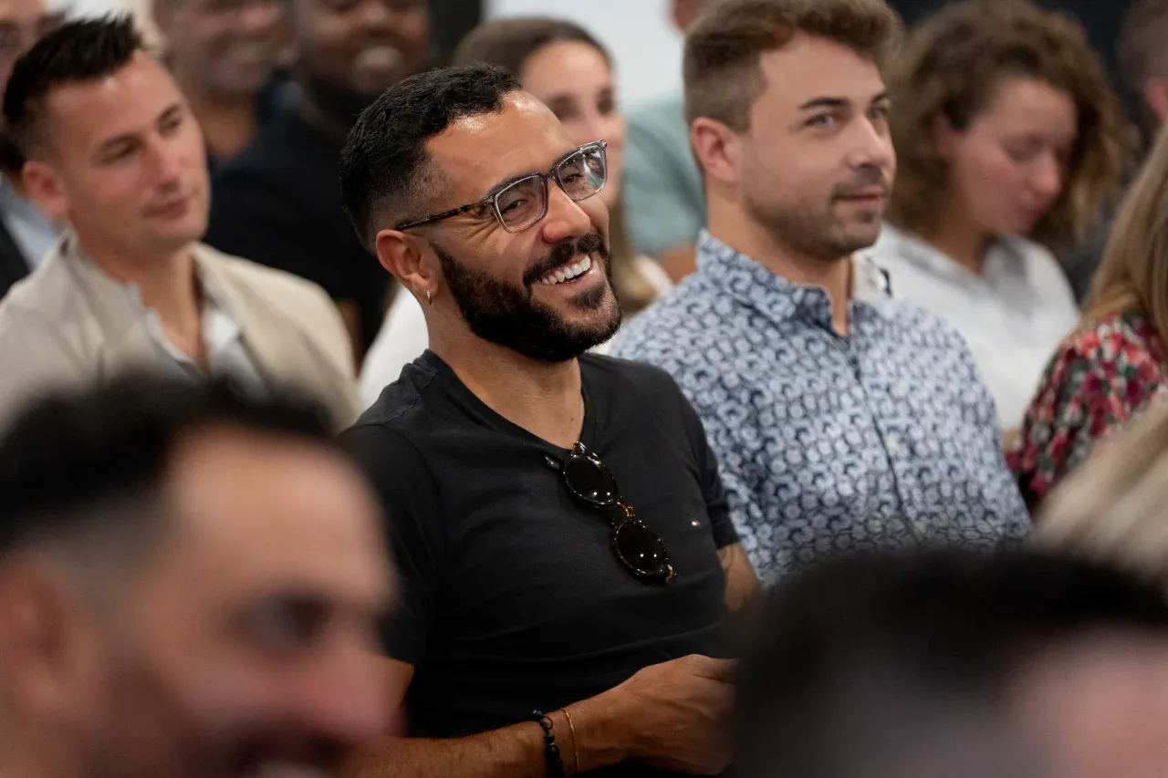 Public attentif et souriant pendant une convention d'entreprise